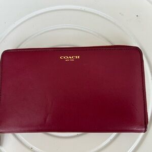 Coach Essential Slim Accordion Zip Around Wallet in a deep red color